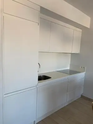a white kitchen with white cabinets and a sink at Arenas de Doñana in Sanlúcar de Barrameda