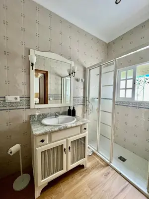 a bathroom with a sink and a mirror at Villa Emilia in Sanlúcar de Barrameda