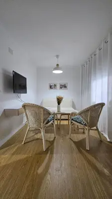 a living room with two chairs and a table at Villa Emilia in Sanlúcar de Barrameda