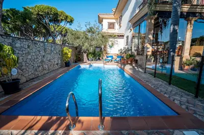 a swimming pool in the middle of a house at Hotel Azalea Playa in Chiclana de la Frontera