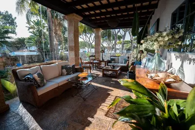 a patio with a couch and a table at Hotel Azalea Playa in Chiclana de la Frontera