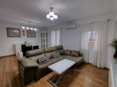 a living room with a couch and a table at Ave 26, piso junto playa in Cádiz