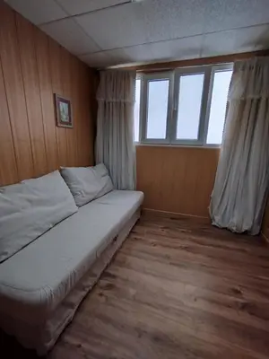 a small bedroom with a bed and a window at Ave 26, piso junto playa in Cádiz