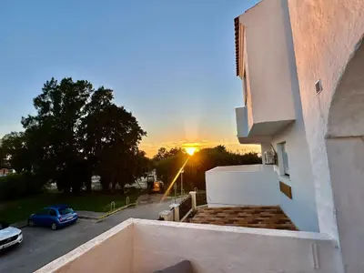 a view of the sunset from the balcony of a building at Piso Bahia in Chiclana de la Frontera