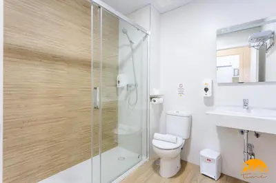 a bathroom with a shower and a toilet and a sink at Casa del Marinero by LiveWork in Cádiz