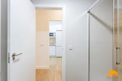 a sliding glass door leading into a kitchen at Casa del Marinero by LiveWork in Cádiz