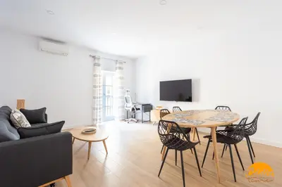 a living room with a table and a couch at Casa del Marinero by LiveWork in Cádiz