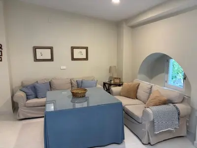 a living room with a couch and a table at Apartamento la Porvera in Jerez de la Frontera