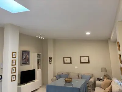 a living room with a couch and a tv at Apartamento la Porvera in Jerez de la Frontera