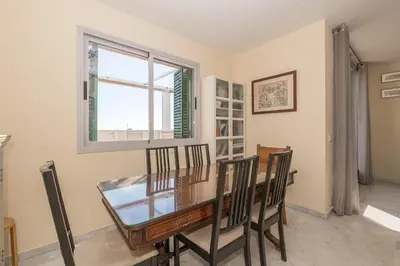 a dining room with a glass table and chairs at Bajamar Deluxe in El Puerto de Santa María