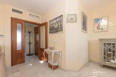 a living room with a fireplace and a door at Bajamar Deluxe in El Puerto de Santa María