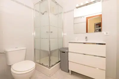 a bathroom with a toilet and a glass shower at Bajamar Deluxe in El Puerto de Santa María