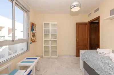 a bedroom with a bed and a window at Bajamar Deluxe in El Puerto de Santa María