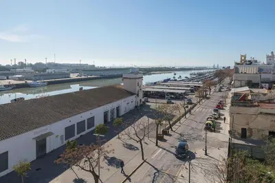 a view of a city with a river and buildings at Bajamar Deluxe in El Puerto de Santa María