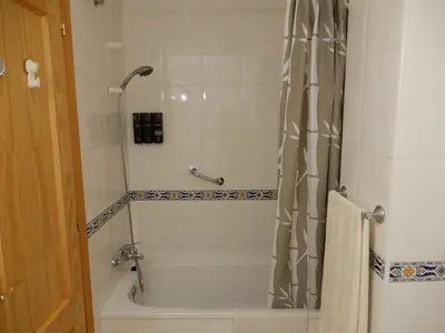 a bathroom with a shower and a tub and a toilet at Apartamento en Playa Ballena III in Rota