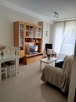 a living room with a couch and a table at Apartamento en Playa Ballena III in Rota