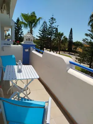 a table and chairs on the balcony of a house at Apartamento en Playa Ballena III in Rota
