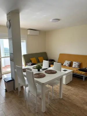 a living room with a white table and chairs at Apartamento Brisa & Mar in El Puerto de Santa María