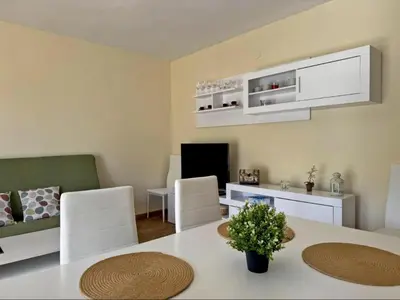 a living room with a table and a living room with a couch at Apartamento Brisa & Mar in El Puerto de Santa María