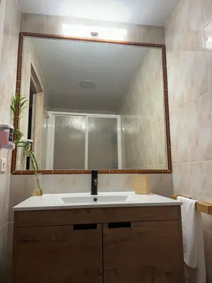 a bathroom with a sink and a large mirror at Apartamento Brisa & Mar in El Puerto de Santa María