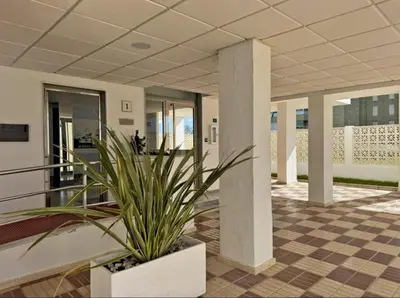 a potted plant in the middle of a lobby at Apartamento Brisa & Mar in El Puerto de Santa María