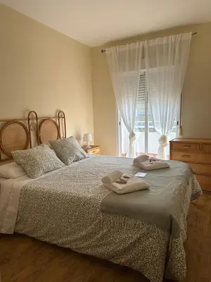 a bedroom with a bed with two towels on it at Apartamento Brisa & Mar in El Puerto de Santa María