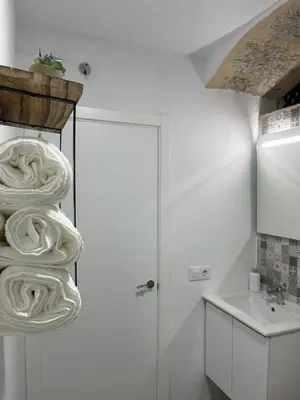 a white kitchen with a sink and a white refrigerator at El Encanto de Jerez in Jerez de la Frontera