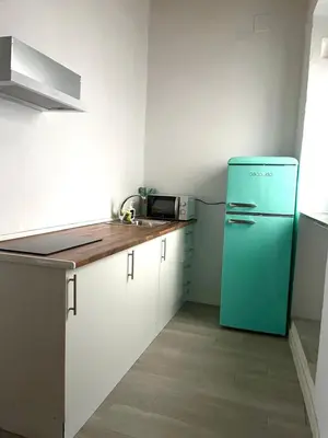 a kitchen with a blue refrigerator and a sink at El Encanto de Jerez in Jerez de la Frontera