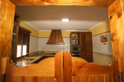 a kitchen with a wooden counter top and a sink at Casa Ana Mari in Conil de la Frontera