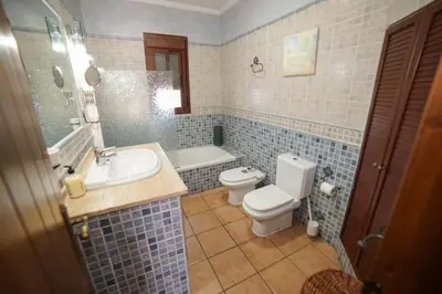 a bathroom with a toilet and a sink and a tub at Casa Ana Mari in Conil de la Frontera