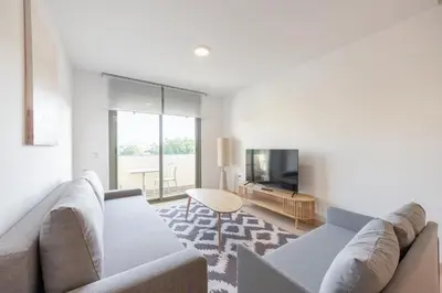 a living room with a couch and a tv at APARTOYOU Apartments - Oasis El Puerto in El Puerto de Santa María