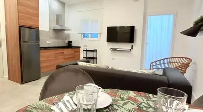 a living room with a couch and a table at El Patio de mama Carmen by RentCadiz in El Puerto de Santa María