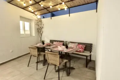 a dining room with a table and chairs and a table and chairsktop at El Patio de mama Carmen by RentCadiz in El Puerto de Santa María