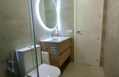 a bathroom with a toilet and a sink and a mirror at El Patio de mama Carmen by RentCadiz in El Puerto de Santa María