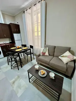 a living room with a couch and a table at Villa María Cádiz centro, 