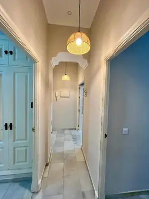 a hallway in a home with a hallway leading to a door at Villa María Cádiz centro, 