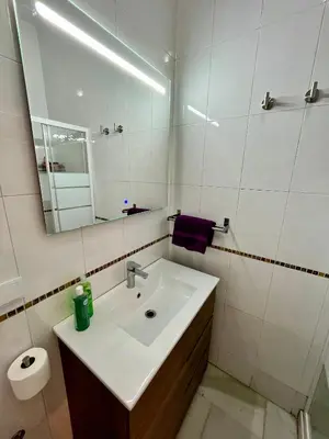 a bathroom with a sink and a mirror at Villa María Cádiz centro, 