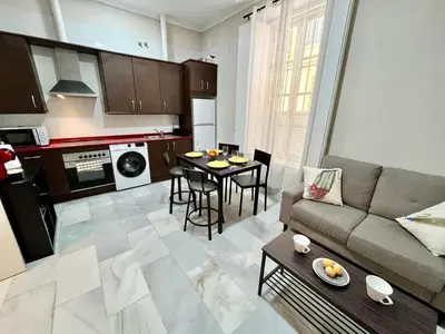 a living room with a couch and a table at Villa María Cádiz centro, 