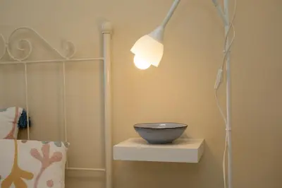 a lamp with a bowl on a shelf in a room at Sibs Sanlucar RIOMAR-Renovado Centrico vistas in Sanlúcar de Barrameda