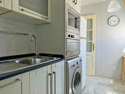 a kitchen with a sink and a washing machine at Apartamento Cielo in El Puerto de Santa María