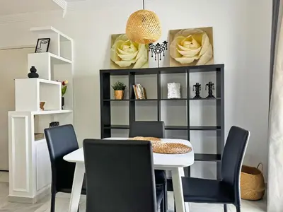 a dining room with a black and white table and chairs at Apartamento Cielo in El Puerto de Santa María