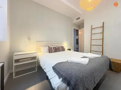 a white bedroom with a bed and a shelf at Ámbar Loft Grupo AC Gestion in Cádiz