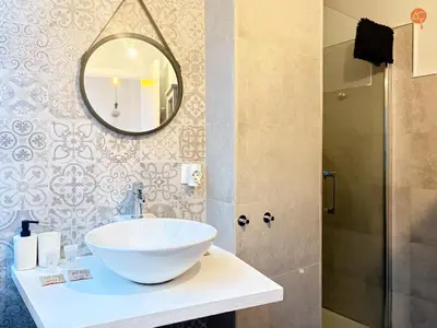 a bathroom with a white sink and a mirror at Ámbar Loft Grupo AC Gestion in Cádiz