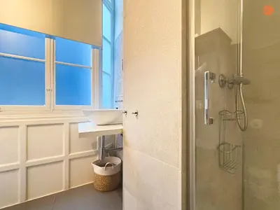 a bathroom with a shower and a sink and a glass door at Ámbar Loft Grupo AC Gestion in Cádiz
