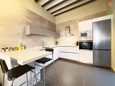 a kitchen with white cabinets and a refrigerator at Ámbar Loft Grupo AC Gestion in Cádiz
