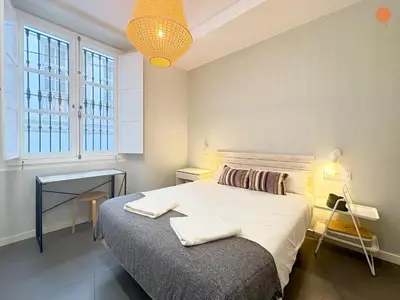 a bedroom with a bed with two towels on it at Ámbar Loft Grupo AC Gestion in Cádiz