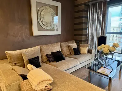 a living room with a couch and a glass table at Terra Boutique Cádiz in Cádiz