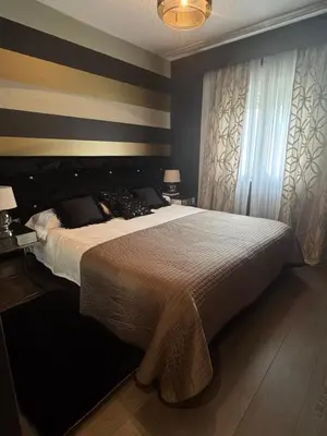 a bedroom with a large bed and two windows at Terra Boutique Cádiz in Cádiz