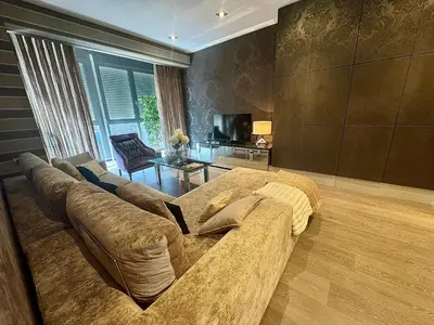 a living room with a couch and a television at Terra Boutique Cádiz in Cádiz