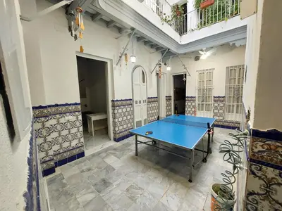 a ping pong table in the middle of a room at Casa Madre Gelart Patrimonio Gaditano del siglo XIX in San Fernando